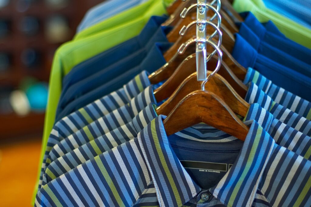 A rack of golf vests hanging in a store.