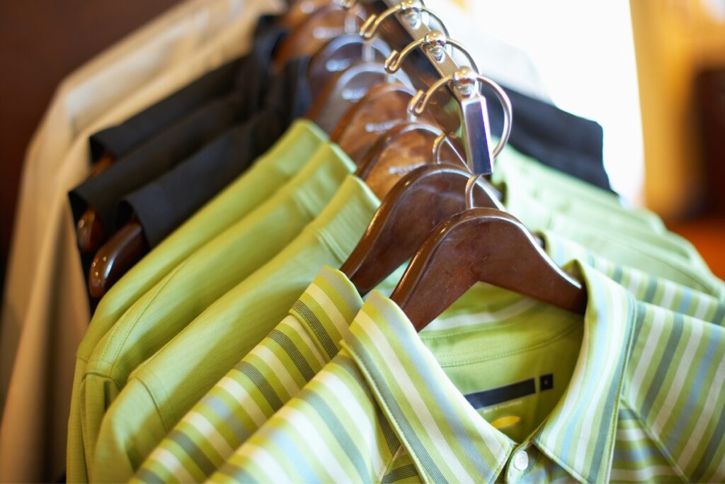 A rack of green and black golf vests.