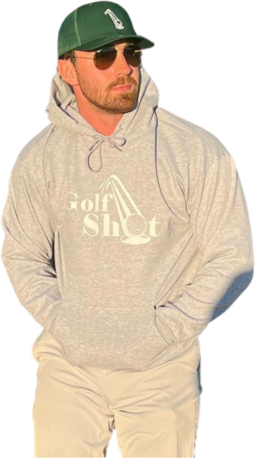 A bearded man wearing sunglasses, a green cap, and a gray hoodie with "Golf Shot" printed on it. He has his hands in his pockets.
